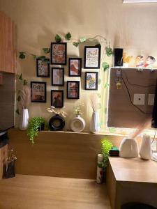 a room with a wall with pictures on the wall at Nest And Rest Stay in Greater Noida