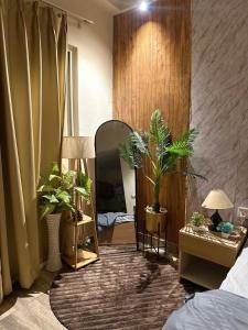 a room with potted plants and a mirror at Nest And Rest Stay in Greater Noida