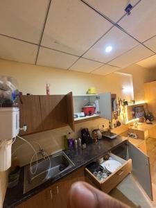 a kitchen with a sink and a counter top at Nest And Rest Stay in Greater Noida +10 photos