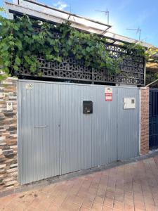 two metal gates with plants on top of them at Serena Boutique Duplex in Madrid
