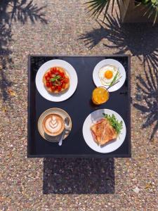 a table with plates of food and a cup of coffee at Da zia Sofia in Torre Lapillo
