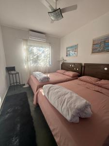 a bedroom with two beds and a window at VILLA ARATOCA in Garça +40 photos