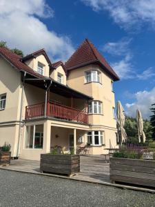 a large house with a balcony on the street at Vila Markéta in Ledeč nad Sázavou