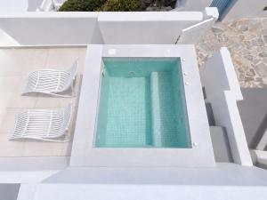 an overhead view of a swimming pool on a building at Santorini Theasis Suites in Imerovigli