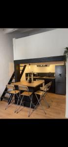 a dining room with a table and chairs at Apparemment Cocooning Ceyreste in Ceyreste