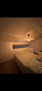 a bedroom with a bed and a ceiling at Apparemment Cocooning Ceyreste in Ceyreste