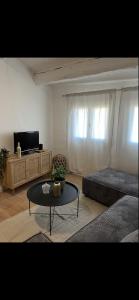 a living room with a bed and a coffee table at Apparemment Cocooning Ceyreste in Ceyreste