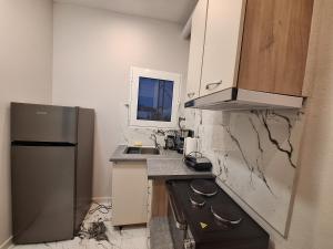 a small kitchen with a sink and a refrigerator at Imeros Summer Home 3 in Ímeros