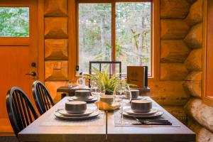a dining room with a table with chairs and a window at Wilderness Retreat in Glacier