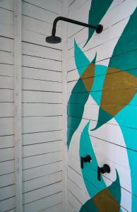 an umbrella painted on the side of a house at El Faro Beach Front by ÓOL Hotels in Holbox Island