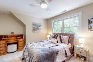 a bedroom with a bed and a dresser and a window at Salisbury Waterfront: Schumaker Pond Paradise! in Salisbury