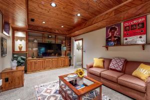 a living room with a couch and a tv at Salisbury Waterfront: Schumaker Pond Paradise! in Salisbury