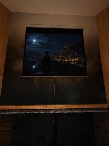 a framed picture of a city at night at 4Sosny, jacuzzi, siłownia, sauna, widok na Śnieżkę in Miłków