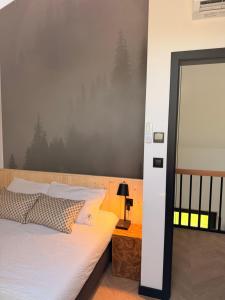 a bedroom with a bed and a large mirror at 4Sosny, jacuzzi, siłownia, sauna, widok na Śnieżkę in Miłków