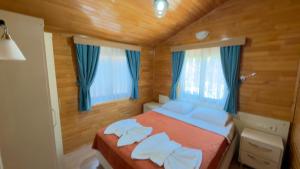 a bedroom with a bed with two white pillows at Villa Efsane Hotel in Cıralı