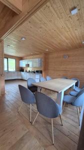 a dining room with a table and blue chairs at Forest House in Yablunytsya