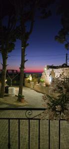 a view of a park at night with a fence at Eagles Nest Guesthouse- Garden Lily House in Batroûn