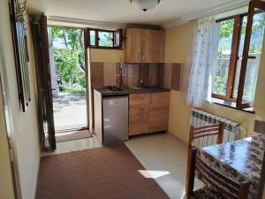a kitchen with a refrigerator and a table in it at Mashtots B&B in Vanadzor