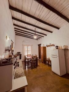 a kitchen with white appliances and a dining room at Apartamento Cerrito in San Rafael