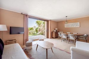 a living room with a table and a dining room at BeLocations - Aldia Garden Seaview in Puntaldia +29 photos