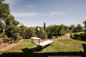 a bench sitting on the grass in a yard at BeLocations - Aldia Garden Seaview in Puntaldia