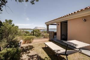 a patio with a table and chairs in front of a house at BeLocations - Aldia Garden Seaview in Puntaldia
