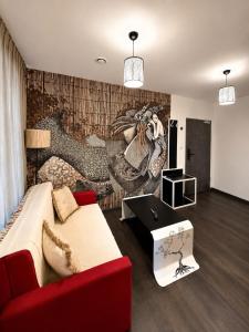 a living room with a red couch and a table at Global Home - Aparthotel - No Contact Check In in Mielec