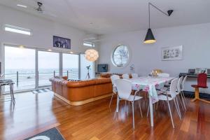 a living room with a table and a couch at VGO1063-Karlsborg-Silverdalen-1 in Karlsborg