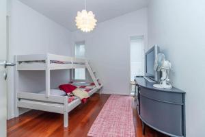 a bedroom with a bunk bed and a television at VGO1063-Karlsborg-Silverdalen-1 in Karlsborg