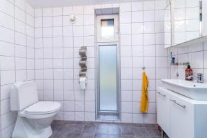 a white bathroom with a toilet and a sink at VGO1063-Karlsborg-Silverdalen-1 in Karlsborg +8 photos