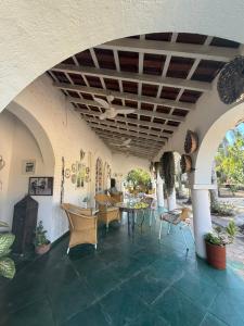 a room with chairs and tables and a ceiling at VILLA ARATOCA in Garça
