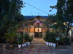 a building with a bunch of potted plants in front of it at SHANKARDHABA&resort in Guwahati