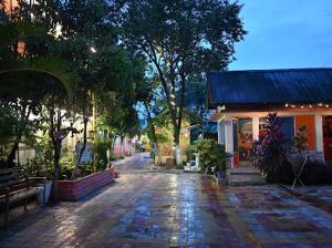 a cobblestone street next to a building with trees at SHANKARDHABA&resort in Guwahati