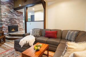 a living room with a couch and a fireplace at Little Haven Cottage in Glacier +31 photos