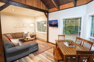 a living room with a couch and a table at Little Haven Cottage in Glacier