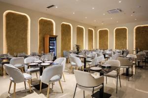 a restaurant with tables and chairs in a room at Best Western Plus The Met Tirana Hotel in Tirana