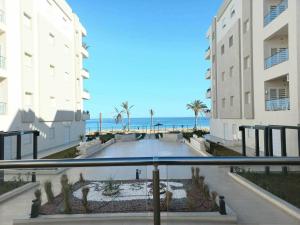 a view of the beach from the balcony of a building at Appartement S2 résidence costa '0751' 8402'79 fr in El Ahmar