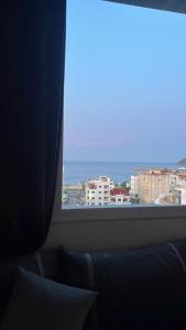 a large window with a view of a city at Mdiaq in M'diq