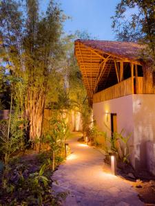 a path leading to a house with lights at Gran Tamoanchan in General Pedro Antonio Santos
