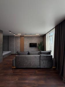 a living room with a couch and a tv at Studio Loft in Fontanka +53 photos