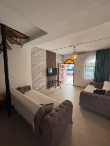 a living room with two beds and a couch at Sincer Otel in Kuşadası