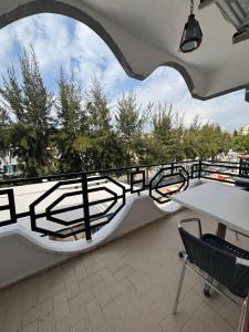 a balcony with a railing and a table and chairs at Sincer Otel in Kuşadası