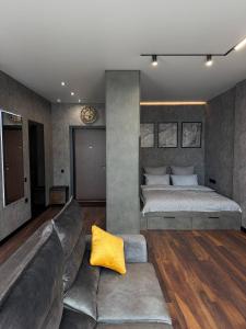 a living room with a couch and a bed at Studio Loft in Fontanka