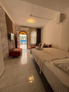 a bedroom with a bed and a living room at Sincer Otel in Kuşadası
