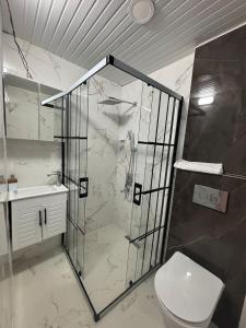 a bathroom with a shower and a toilet at Sincer Otel in Kuşadası +13 photos