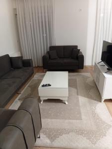 a living room with a couch and a coffee table at Pristhine Stay Inn 20 in Prishtinë