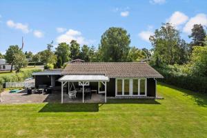 a small black house with a large yard at LL275-svendborg-Stenklovervej-2 in Svendborg +14 photos