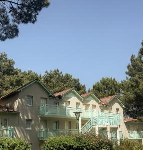 a large apartment building with balconies and trees at La Perle des Pins LACANAU OCEAN in Lacanau