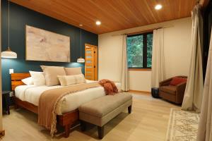 a bedroom with a large bed and a chair at Aspire at Mount Baker in Glacier
