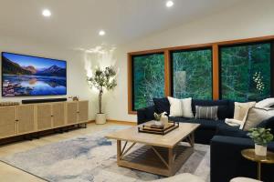 a living room with a blue couch and a tv at Aspire at Mount Baker in Glacier